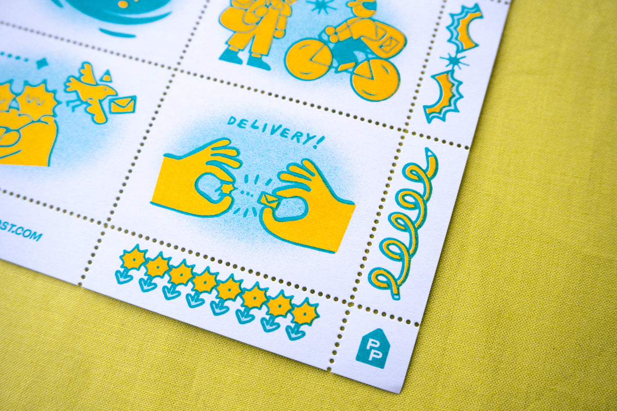 A close-up of a risograph printed postage stamp sheet with colorful cartoon illustrations and pinhole perforated cinderella stamps placed on a yellow textured surface. The sheet includes cute graphics, designed by a small artist.