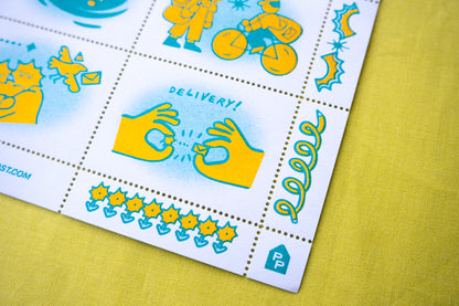 A close-up of a risograph printed postage stamp sheet with colorful cartoon illustrations and pinhole perforated cinderella stamps placed on a yellow textured surface. The sheet includes cute graphics, designed by a small artist.